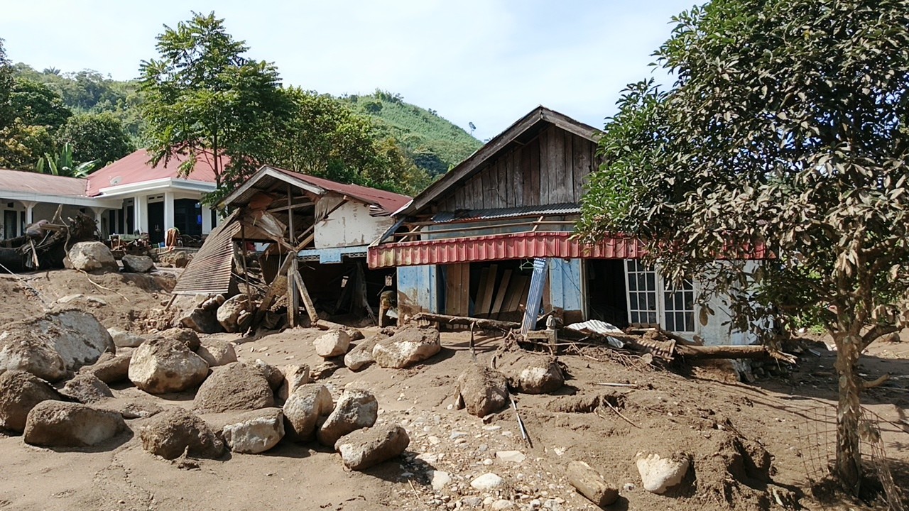 Rumah warga yang rusak parah dan tertimbun material batu serta lumpur pascabencana galodo di Solok.